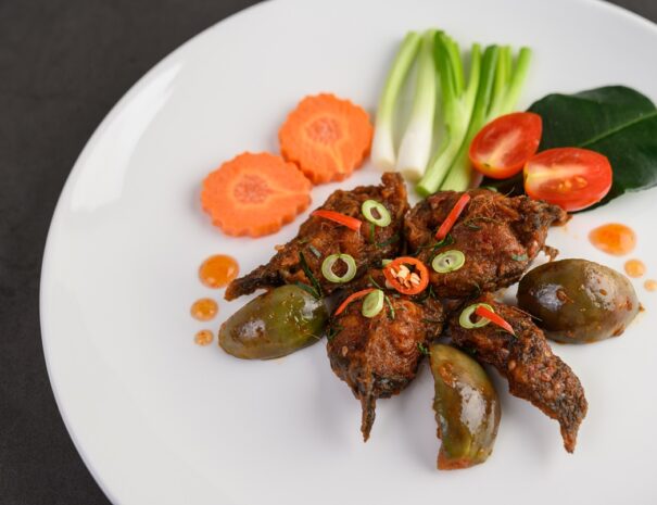 Spicy Fried Stir Catfish on white plate, Thai food. Selective focus